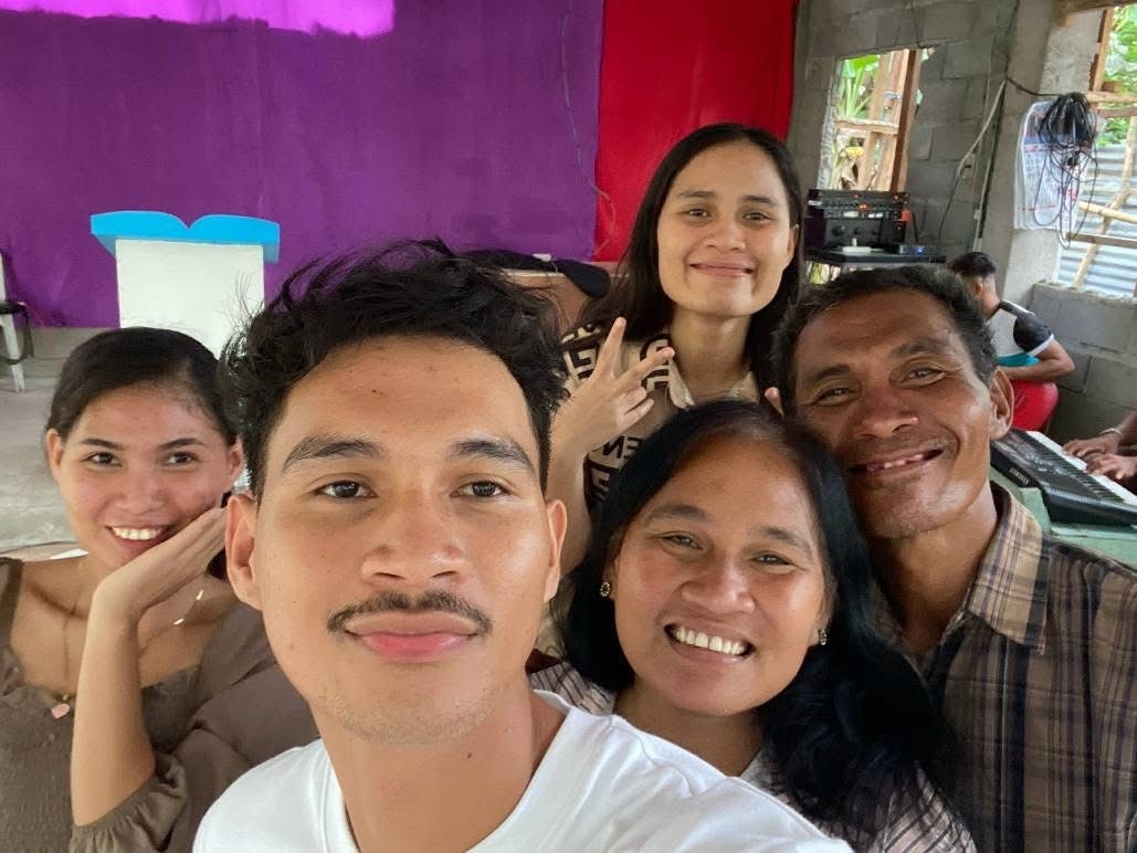 Andrew Vicente with his family in the Philippines